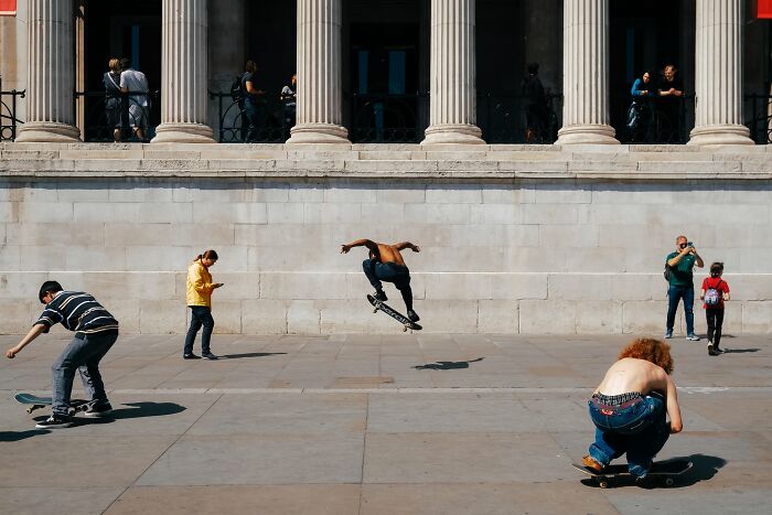 Street photos showing skateboarders performing tricks in an urban setting, capturing everyday life moments with a magical feel.