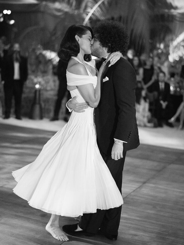 Selena Gomez and her partner sharing a kiss during a wedding dance amid fans suspicious of kidney donor rumors.