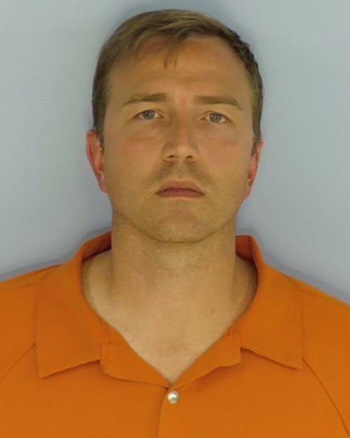 Healthcare exec in orange shirt pictured in mugshot related to leaving baby alone at the beach for an hour incident. Healthcare exec in orange shirt pictured in mugshot related to leaving baby alone at the beach for an hour incident.