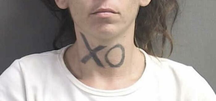 Close-up of a person with a neck tattoo featuring large XO letters, an example of unusual tattoos people allowed on their bodies.