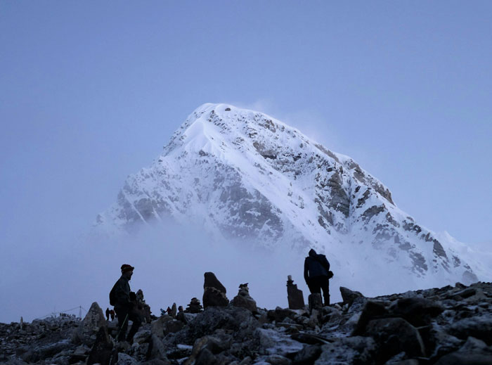 Hikers near a snowy mountain peak illustrating a man who gets majorly hurt after wife asks to cancel anniversary trip. Hikers near a snowy mountain peak illustrating a man who gets majorly hurt after wife asks to cancel anniversary trip.