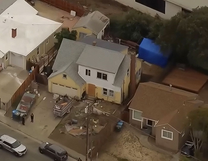 Aerial view of a hoarder's home where a missing woman's body was discovered behind a secret wall. Aerial view of a hoarder's home where a missing woman's body was discovered behind a secret wall.