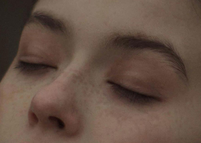 Close-up of a person's face with eyes closed, showing natural skin texture, illustrating life hacks discovered accidentally.