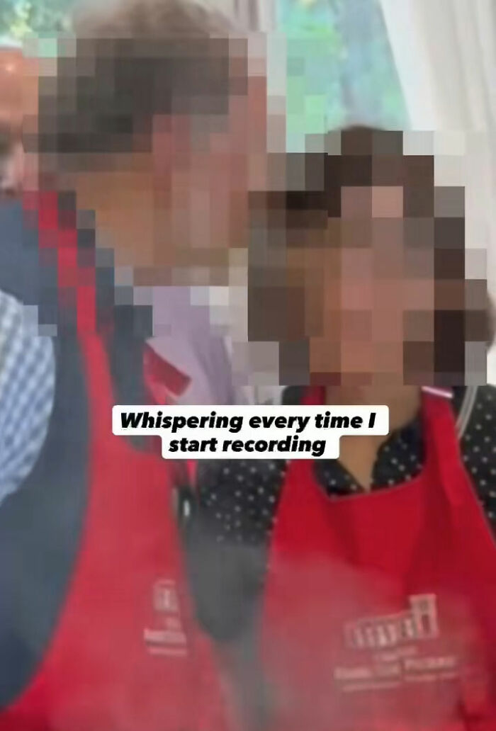 Couple wearing red aprons, capturing vacation regrets with Meta glasses, reflecting on uncomfortable recording moments.