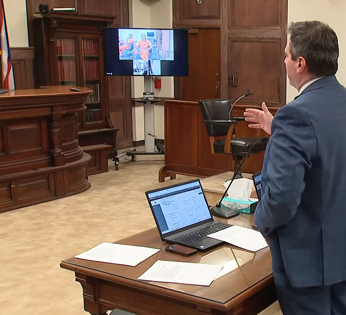 Lawyer presenting evidence in courtroom after pit bull attack on 6-month-old baby, father pleading guilty case discussion.