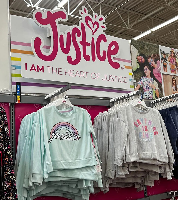 Justice brand clothing display featuring colorful hoodies and sweatshirts supporting kids&rsquo; clothes bullying awareness.