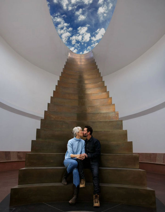 Couple sitting on large staircase under open sky, symbolizing Keanu Reeves finally breaking silence on marriage rumors.