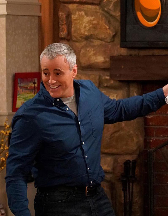 Matt LeBlanc smiling indoors wearing a blue shirt, reappearing as Joey in unaired episodes after rare outing with daughter.