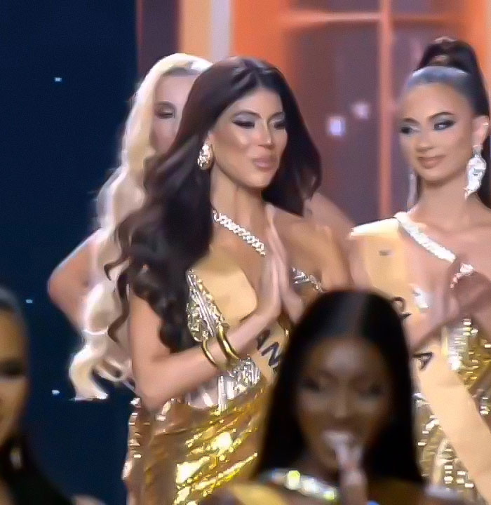 Miss Panama onstage in a gold dress, striking a pose during a pageant moment that viewers found awkward and mortifying.