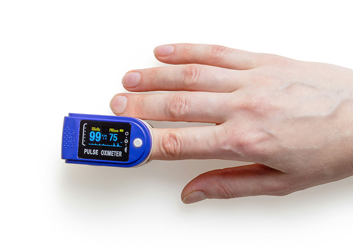 Pulse oximeter on a finger measuring oxygen levels illustrating scientific proof of alternative breathing methods through the bottom. Pulse oximeter on a finger measuring oxygen levels illustrating scientific proof of alternative breathing methods through the bottom.