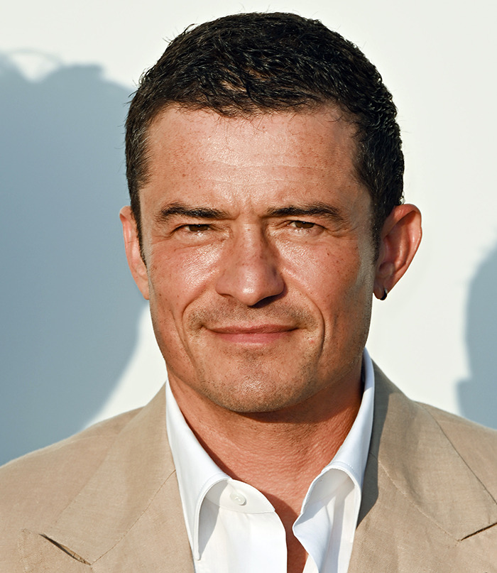 Man in beige suit jacket and white shirt outdoors, discussing Katy Perry and Justin Trudeau romance expert claims. Man in beige suit jacket and white shirt outdoors, discussing Katy Perry and Justin Trudeau romance expert claims.