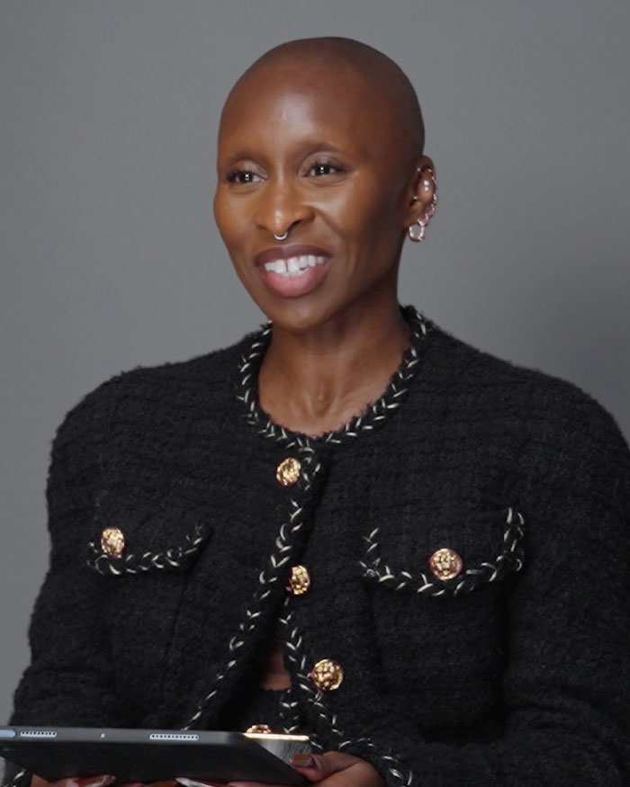 Cynthia Erivo wearing a black textured jacket and smiling during a discussion about the controversial Harper&rsquo;s Bazaar shoot.