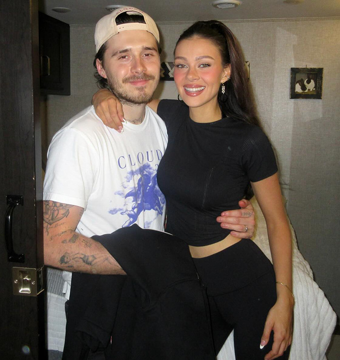 Brooklyn Beckham and Nicola Peltz smiling and posing together amid rumored family feud involving Victoria Beckham.