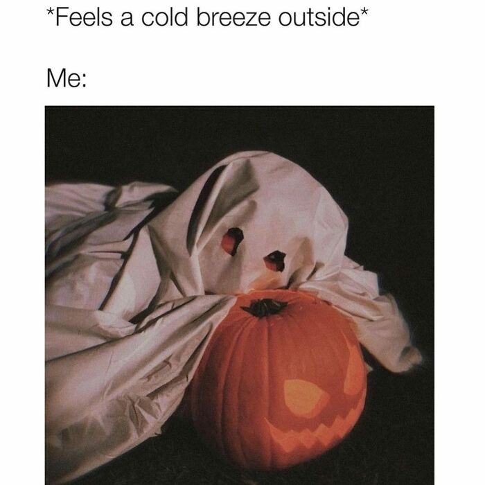 Person dressed as a ghost hugging a jack-o'-lantern, capturing hilarious and relatable Halloween and horror memes.