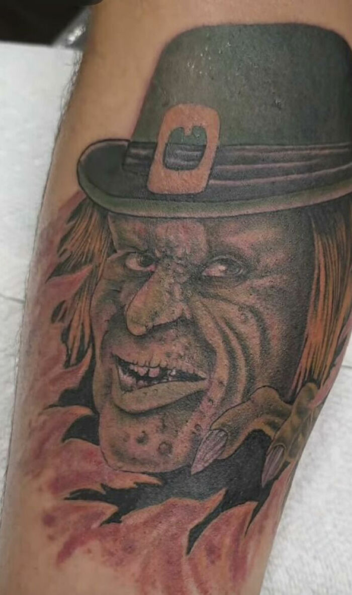 Tattoo of a sinister face with a hat and long nails, showcasing one of the most shocking tattoos people allowed on their bodies