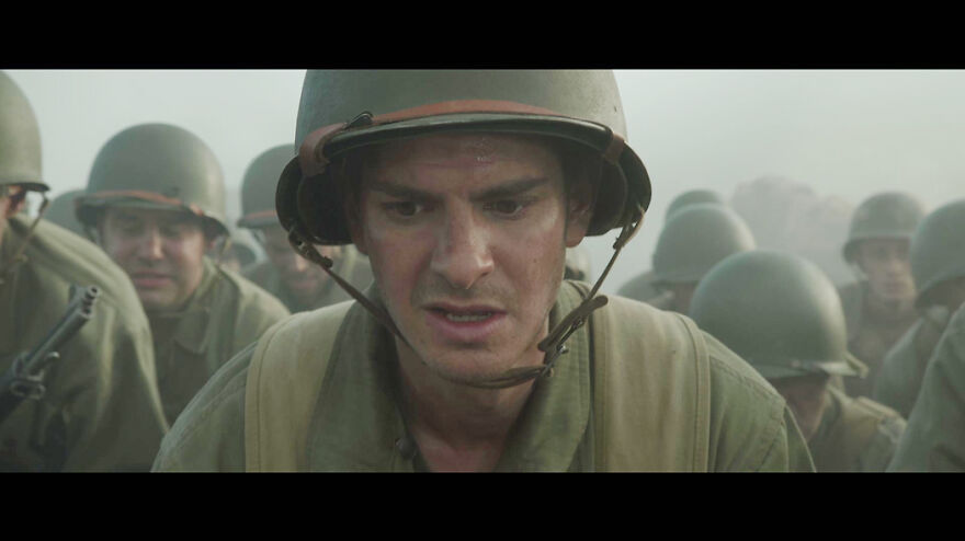Soldier in military gear among troops in a tense scene from movies based on true stories that feel impossible to believe.