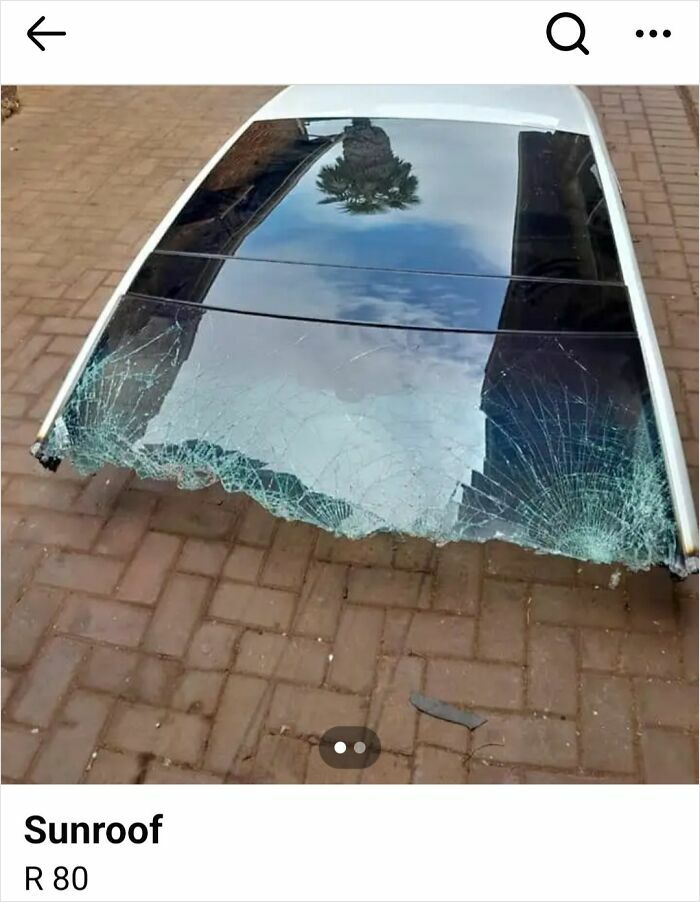 Broken car sunroof with shattered glass lying on pavement, an example of unhinged things people thought they could sell online.