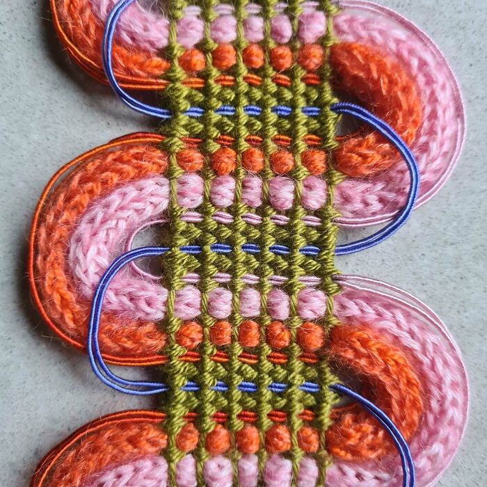 Close-up of mesmerizing textile creation featuring colorful threads woven into intricate patterns.