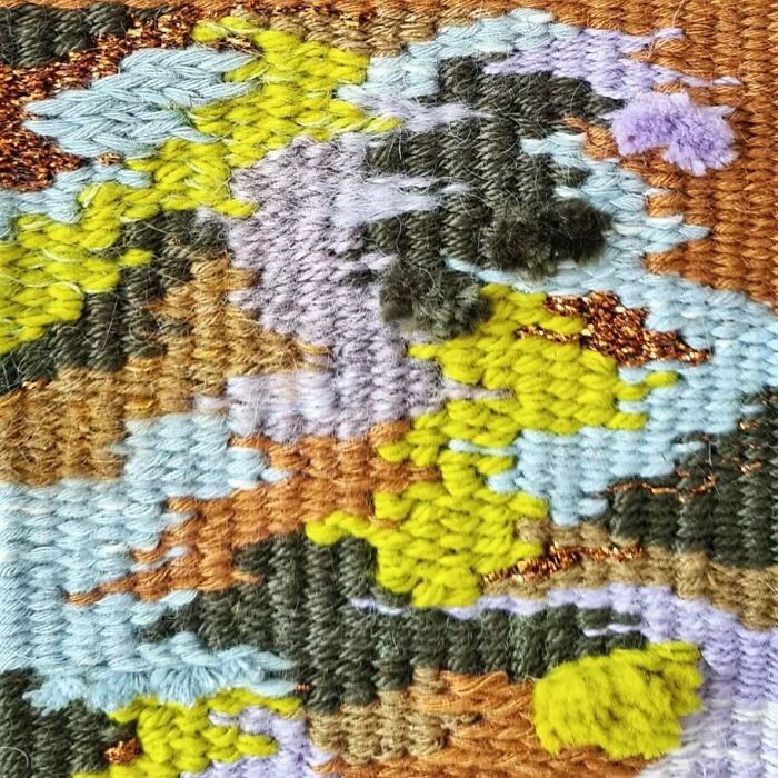 Close-up of mesmerizing textile creation showcasing detailed threads and colorful woven patterns by the artist.