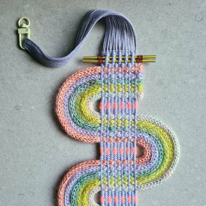 Colorful textile creation with woven threads forming intricate patterns and loops in a mesmerizing artistic design.