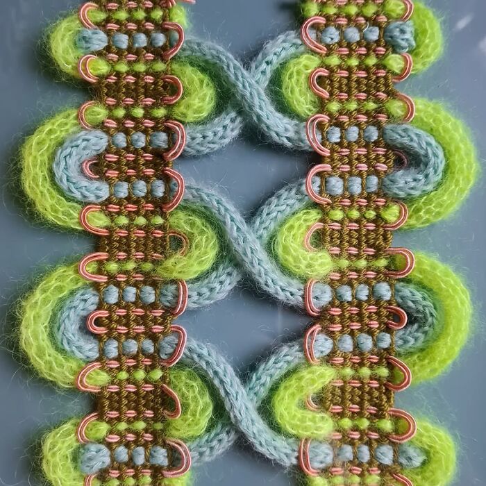 Green and blue yarn threads woven intricately with copper wire in a mesmerizing textile creation pattern.