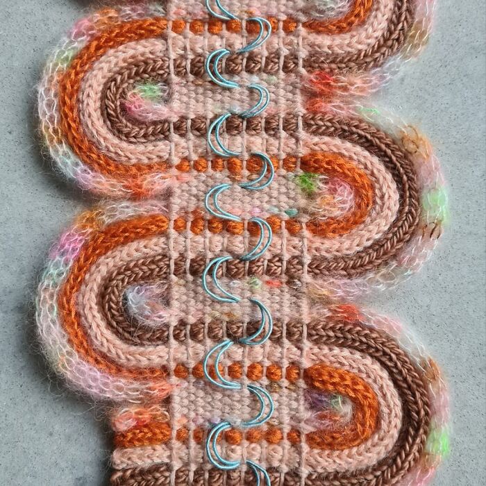 Close-up of mesmerizing textile creations featuring colorful threads and intricate knitting patterns with decorative metal rings.