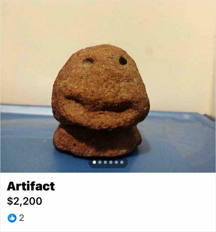 Small brown artifact resembling a face displayed on a blue surface, one of unhinged things people thought they could sell online.