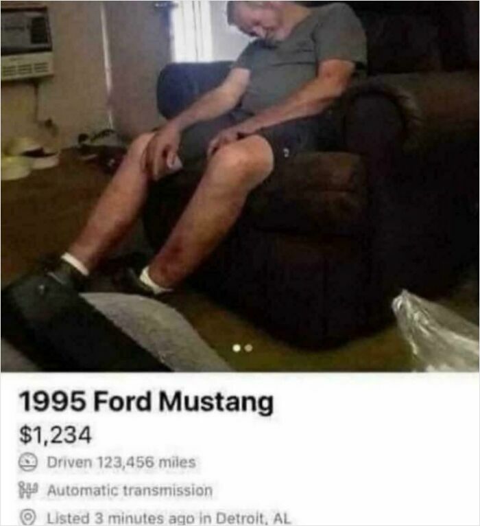 Man asleep in living room next to online listing for 1995 Ford Mustang with high mileage for sale.