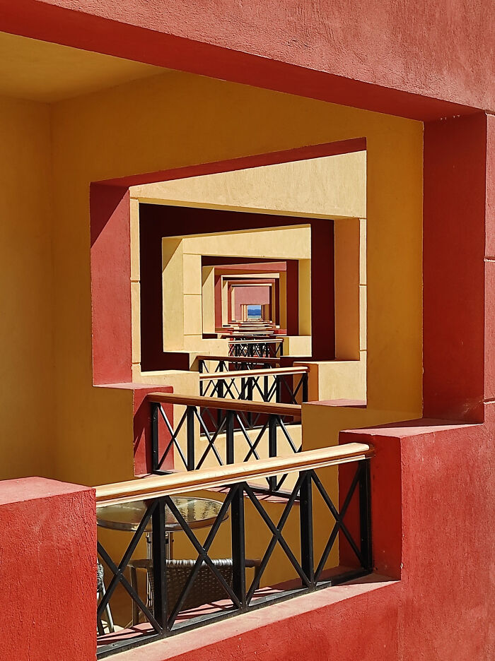 Colorful architectural corridor with repeating frames creating a surreal, unphotoshopped perspective that looks fake but is real.