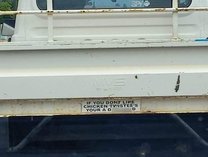 Funny bumper sticker on a truck saying if you don't like chicken, twist your arm shared by drivers on the road.