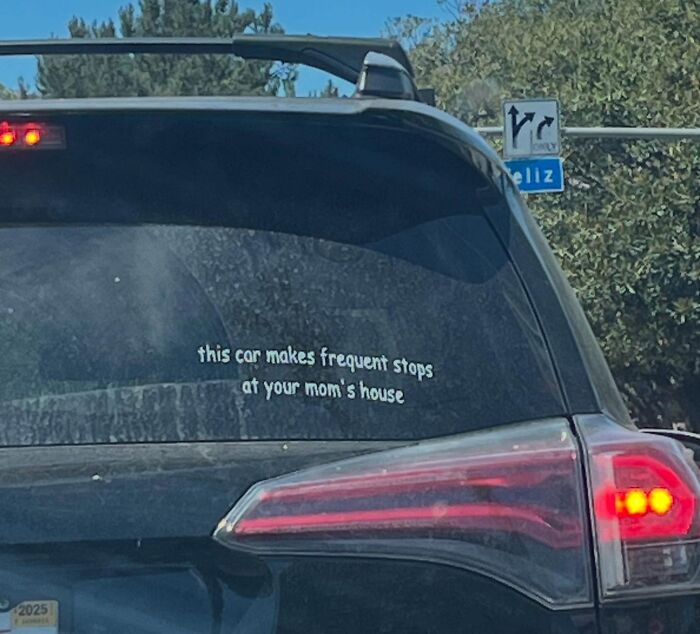 Funny bumper sticker on a black SUV stating this car makes frequent stops at your mom's house, spotted on the road.