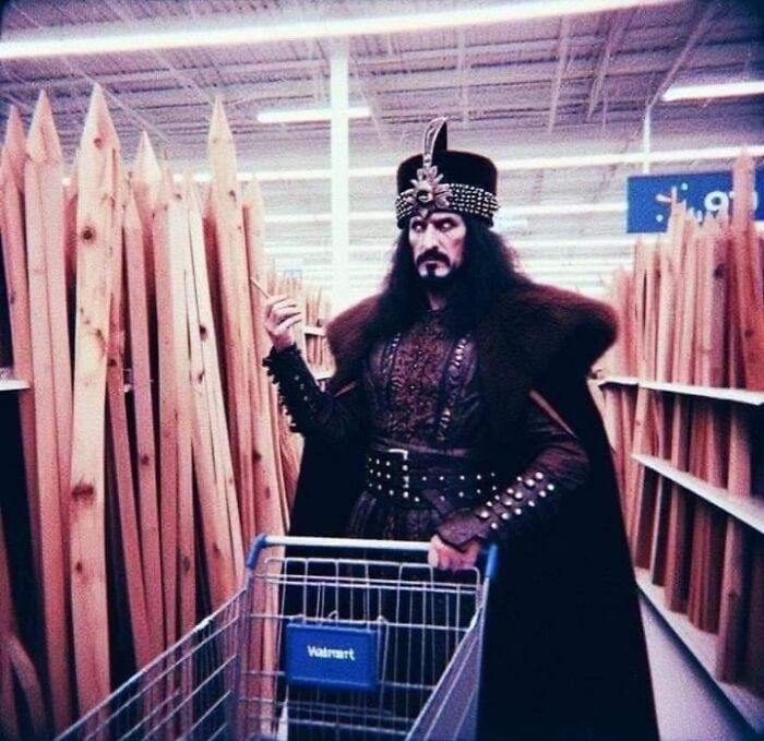 Man dressed as Eastern European historical figure pushing Walmart shopping cart in aisle with wooden planks, Eastern Europe meme.