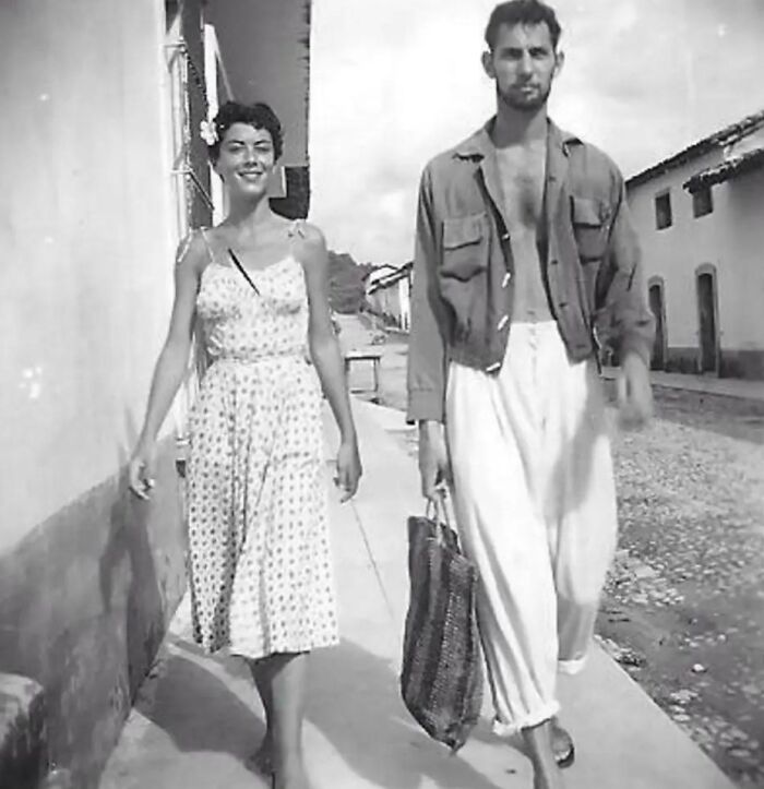Vintage vacation pic of a man and woman walking on a sunny street, capturing moments before cell phones had cameras.