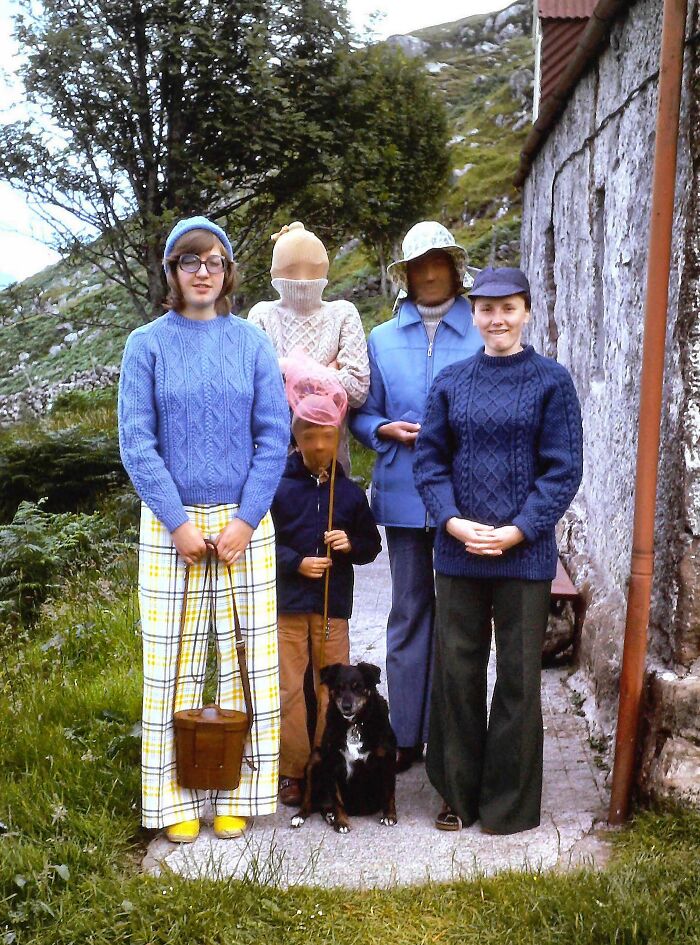 Group wearing vintage vacation clothes with a dog outdoors, capturing vacation pics from a time when cell phones didn’t have cameras.