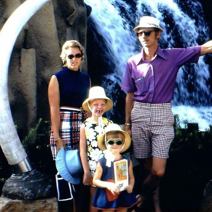 Family posing on vacation near a waterfall, vintage style from the era before cell phones had cameras.
