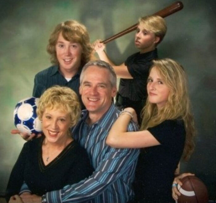 Family photo with awkward poses and props, showing a humorous and cringed moment captured forever online.