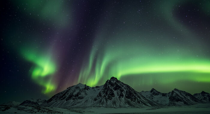 Northern Lights Dancing Over Mountains