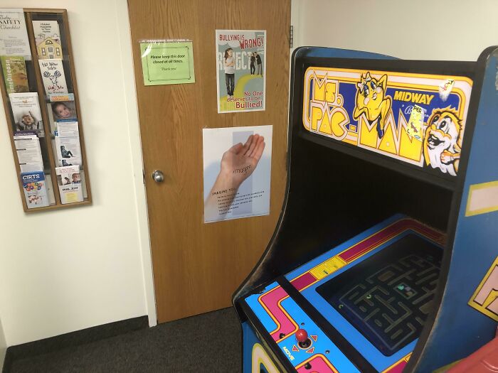 Retro Ms. Pac-Man arcade machine in a medical waiting room, showcasing doctors' efforts to put patients at ease.
