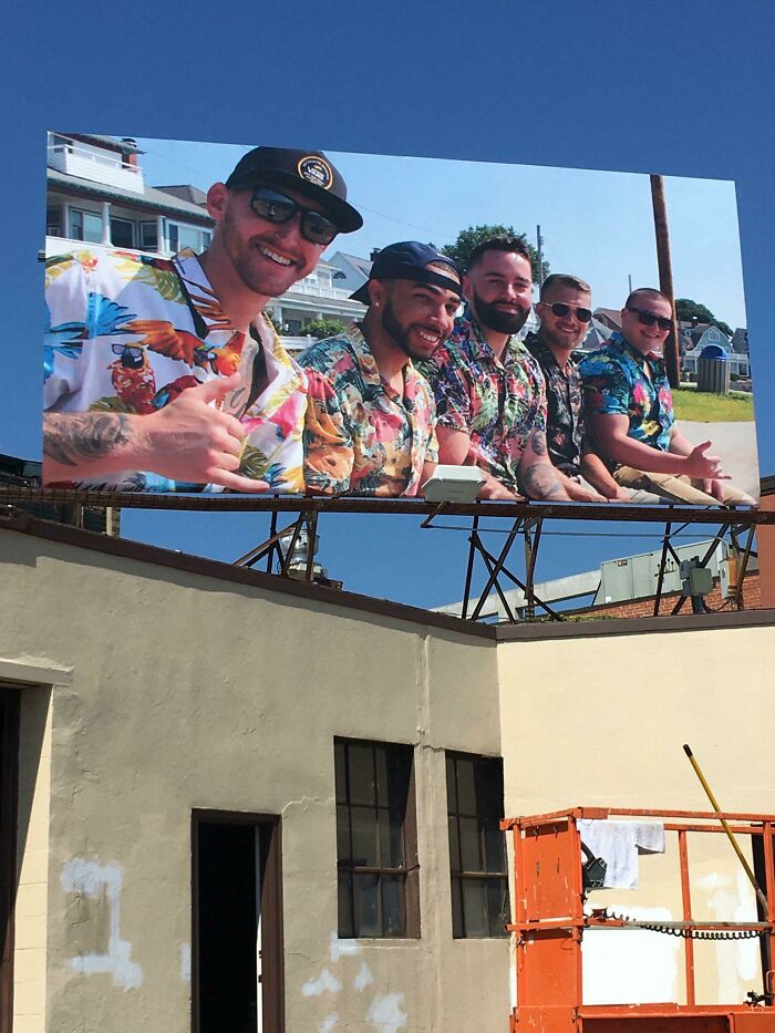 Billboard showing five men in colorful shirts smiling and posing, an example of funny and weird billboards.