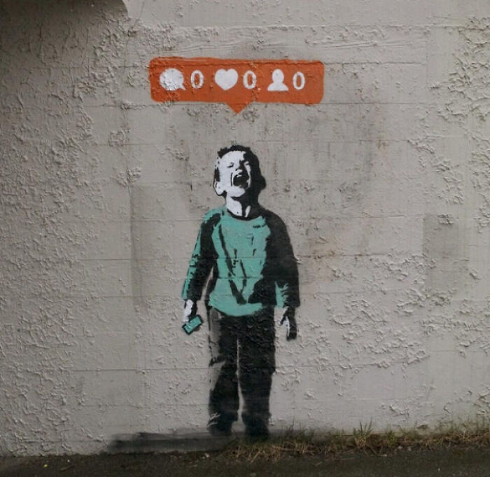 Street art of a boy looking up at a social media notification with zero likes and no followers on a textured wall.