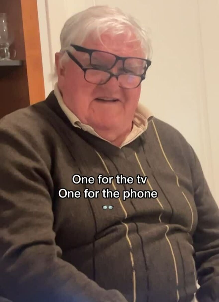Elderly man wearing two pairs of glasses, illustrating a dad joke about needing one for TV and one for phone.