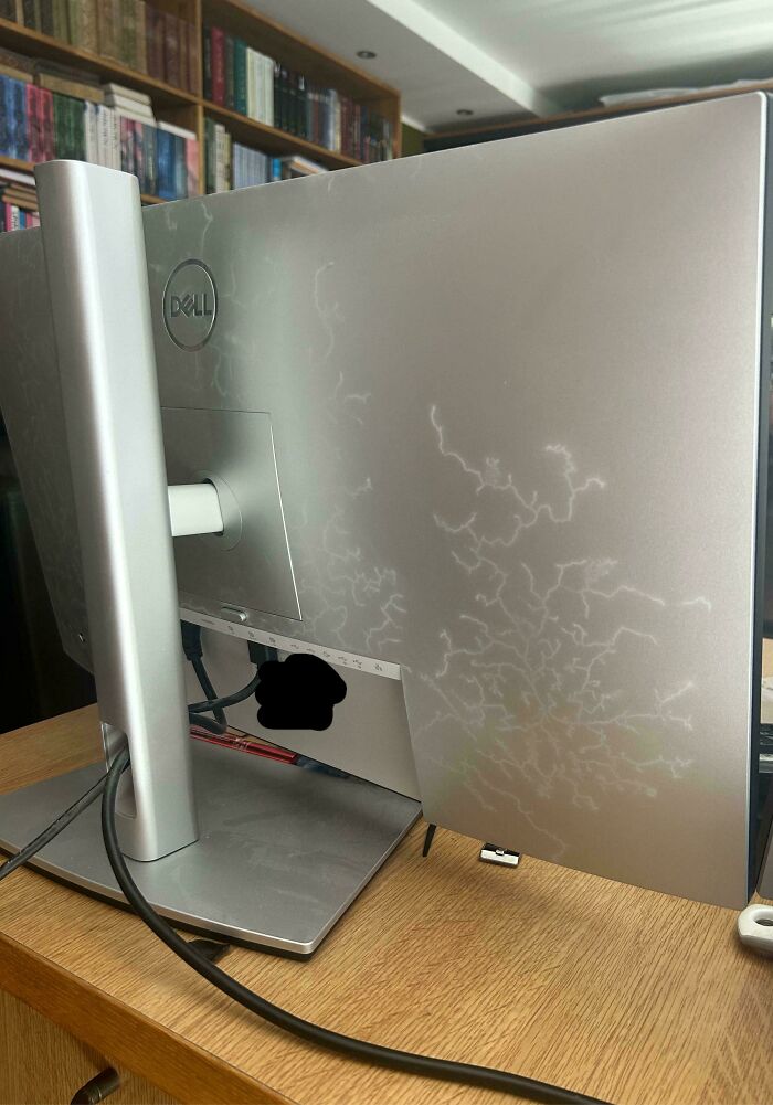Dell monitor showing white discoloration patterns on the back panel, illustrating electronics handled the wrong way.