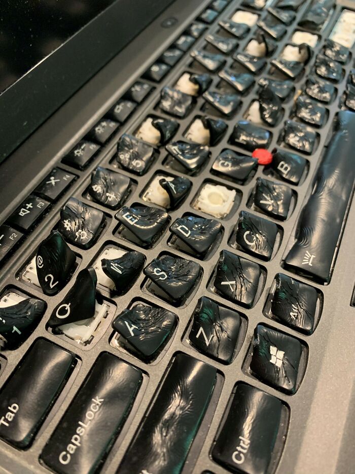 Damaged laptop keyboard with melted and warped keys illustrating painful electronics handling mistake.