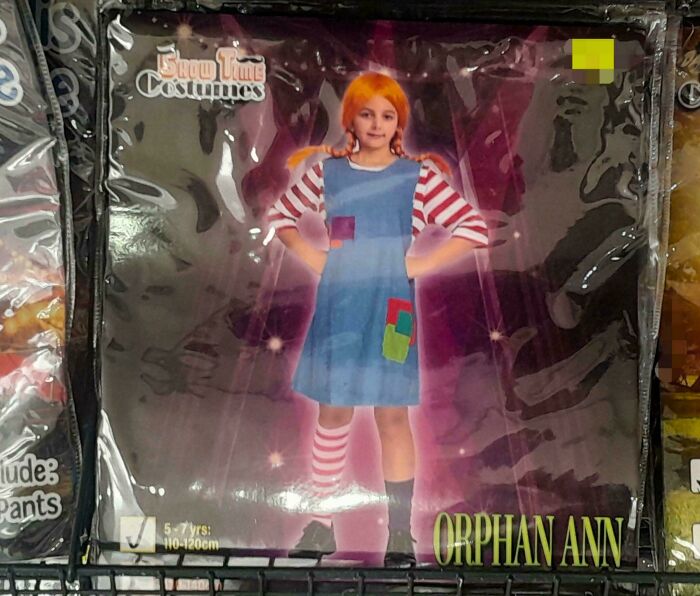 Off-brand Halloween costume of a girl with orange hair in a blue dress and striped sleeves, part of funny Halloween costumes.