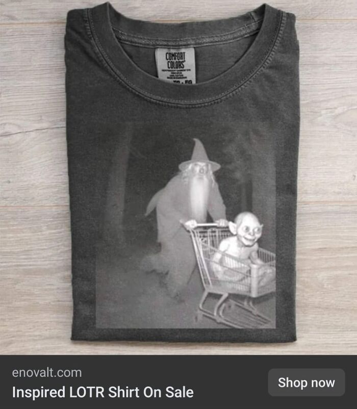 Black t-shirt featuring a weird purchase design with a wizard pushing a creature in a shopping cart, odd gifts idea.