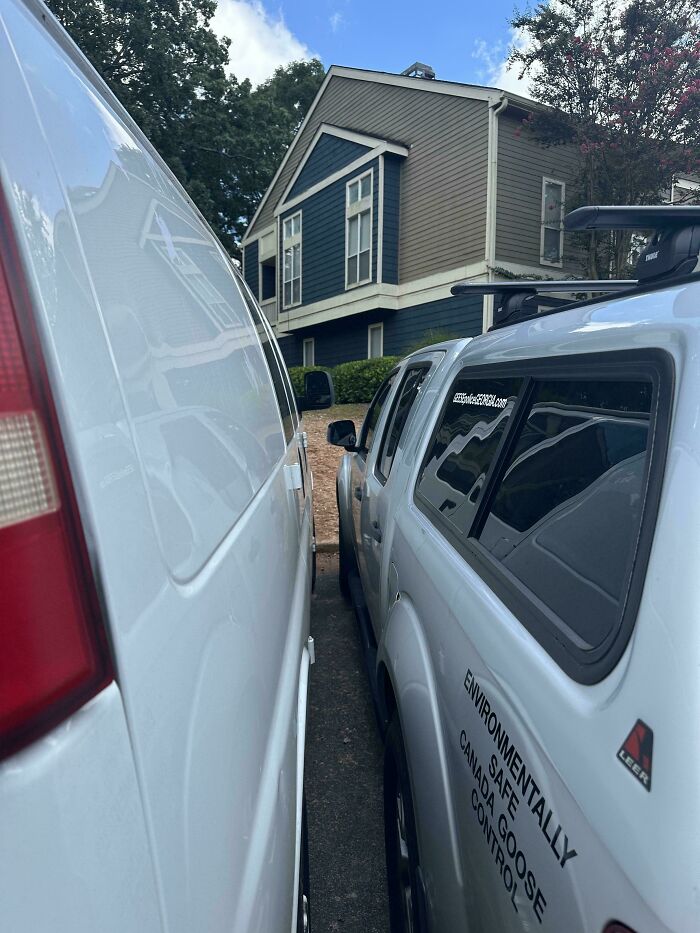Two vehicles parked extremely close between them, illustrating a mildly infuriating thing testing patience.