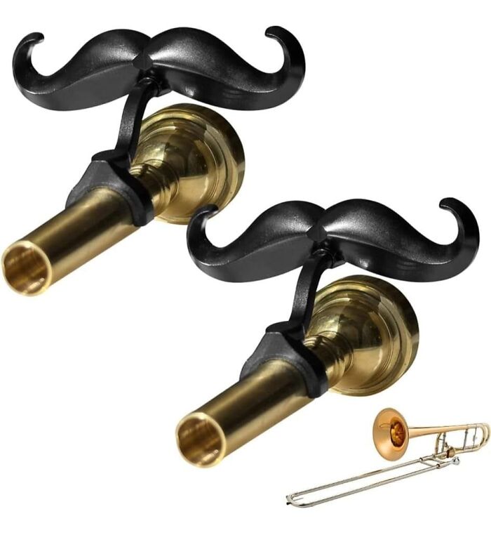 Pair of brass trombone mouthpieces with black mustache-shaped holders, quirky and weirdest purchases collectible items.