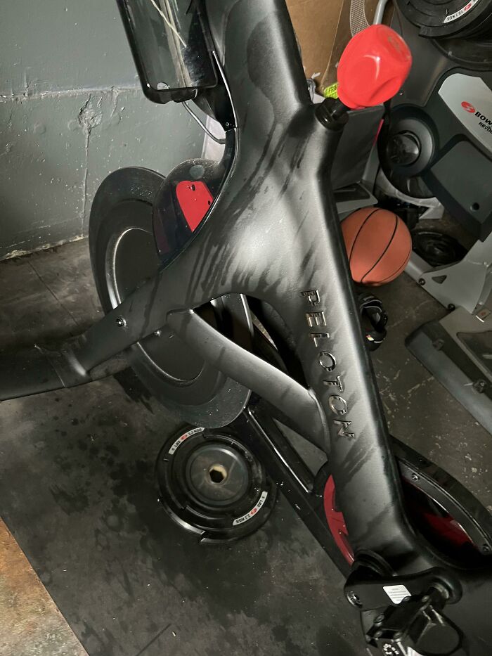 Peloton exercise bike with sweat stains on the frame, showing mildly infuriating signs of intense use and testing patience.