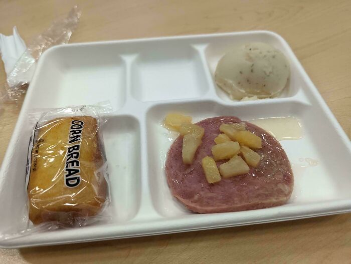 Unholy food pic of a school lunch tray with processed meat, canned pineapple chunks, a biscuit, and mashed potatoes.
