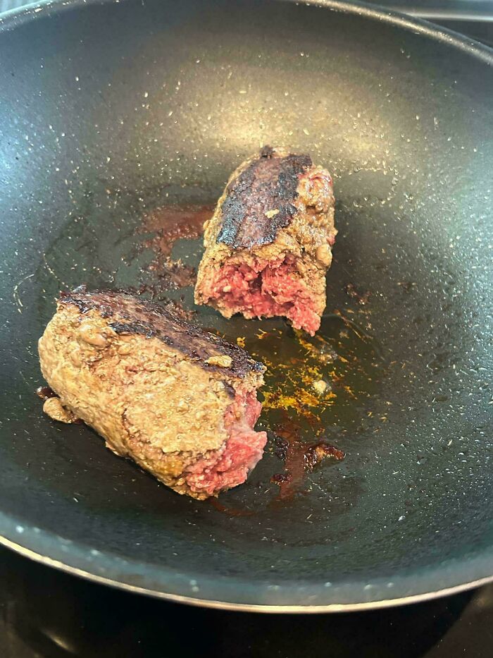 Partially cooked meat pieces in a pan showing unholy food pics that look anything but appetizing.